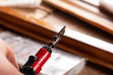 restoration and elimination of defects on a wooden surface using hot wax.