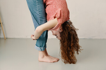 Young redhead woman bending forwards doing stretch exercises