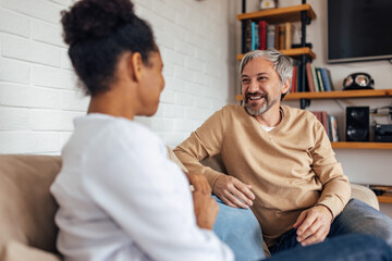 People relaxing at home, indoor, talking to each other.
