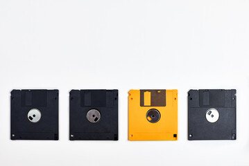 Several floppy disks of different colors on a white background.