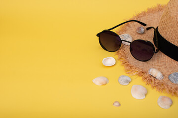 Fototapeta na wymiar summer background postcard. straw hat, sunglasses, seashells. mock up beach accessories. 