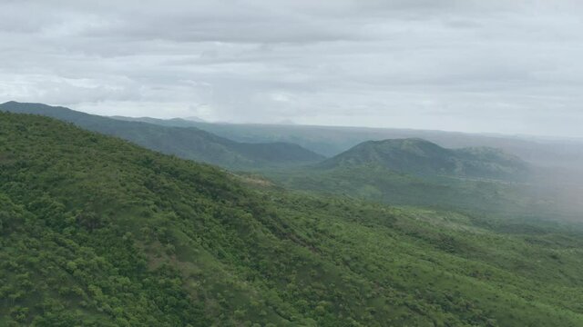 Aerial view near Omo Valley in Ethiopia, Africa. Landscape with trees and surrounded by mountains, peaks and ridges. 4K Drone video of Africa, the place from which humanity was born.