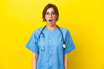 Surgeon doctor woman isolated on yellow background with surprise facial expression