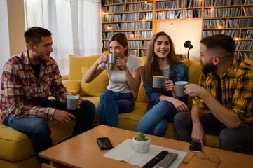 A group of friends hanging out on a house party and drinking coffee
