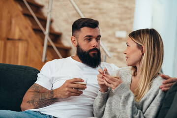 Young beautiful couple drinking coffee in the morning
