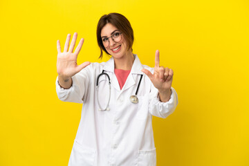 Doctor woman isolated on yellow background counting seven with fingers
