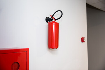 Fire extinguisher on a white wall