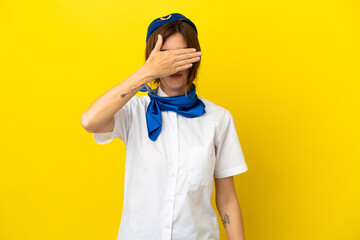 Airplane stewardess woman isolated on yellow background covering eyes by hands. Do not want to see something