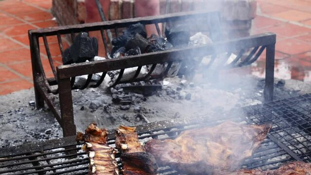 Parrilla, Smoky grill with pieces of a traditional Argentinian barbecue or asado