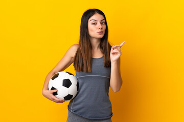 Young football player woman isolated on yellow background intending to realizes the solution while lifting a finger up