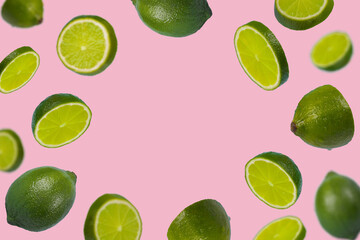 Frame of sliced fresh green lime isolated on light pink background.