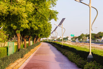 Dubai, UAE - 05.21.2021 - Jogging track in Nad Al Hamar park, early in the morning. Lamp post powered by solar panels can be seen in the picture. Outdoors