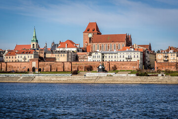 Obraz premium Cathedral and Holy Spirit church tower, historic part of Torun city over Vistula River, Poland