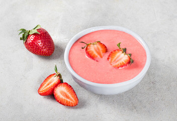 Fresh Strawberry Cream soup in a bowl on a light gray background