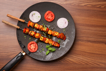 Tawa Paneer tikka with green chutney cooking preparing pan fried cottage cheese on skewers , Indian appetizer Delhi, Rajasthan India. Indian vegetarian starter side dish roti, Chapati, naan 