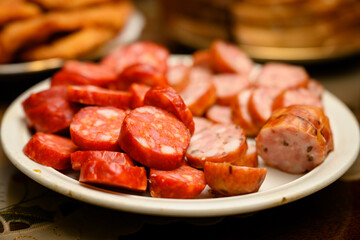 Sausage sliced on wheels on a plate.