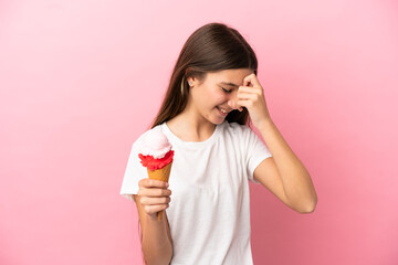 Little girl with a cornet ice cream over isolated pink background laughing