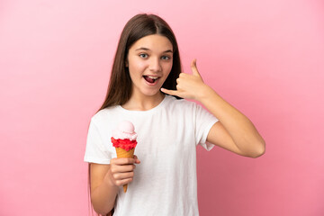 Little girl with a cornet ice cream over isolated pink background making phone gesture. Call me back sign