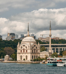 Fototapeta na wymiar Dolmabahce Mosque view in Istanbul. View from the sea of Dolmabahce Mosque on the banks of the Bosphorus, with Dolmabahce Palace in the distance.