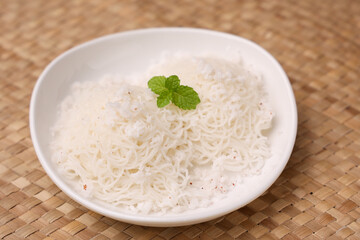 Noolappam , idiyappam rice noodles, string hopper popular traditional steam cooked Kerala breakfast dish with hot and spicy chickpea curry,  Tamil Nadu, India. South Indian noolputtu Sri lankan food.
