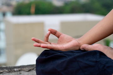 Close up a female hand with fingers in Gyan mudra symbol of wisdom, Indian girl practice yoga...