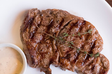 Steak on a white plate. Fried meat serving in a restaurant