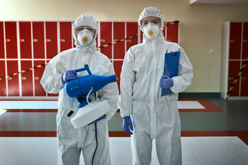 Portrait of team in disinfection suits ready for disinfection