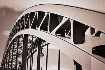 Abstract monochrome image of arch of modern steel bar arch bridge