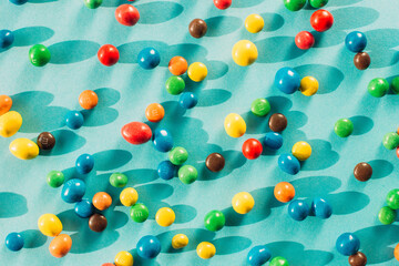 Chocolate multicolored candy dragee on a blue background