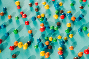 Chocolate multicolored candy dragee on a blue background