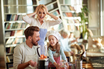 A young happy family love preparing a meal at home together. Family, leisure, together