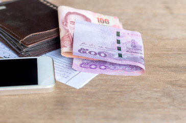 Cash, baht, banknotes placed on the wooden floor
