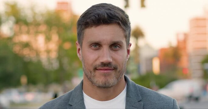 Close up of elderly man getting younger. Rejuvenation skin process. Handsome businessman smiling in a big city. His wrinkles, grey hair and age spots disappear.