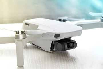 Gray mini quadcopter on the background of the window