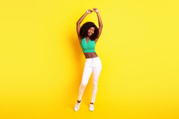 Full length body size photo girl dancing overjoyed relaxing on weekend isolated vibrant yellow color background