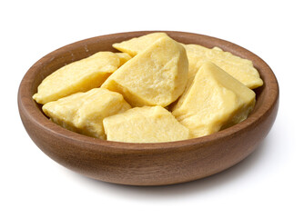 raw cocoa butters in the wooden plate, isolated on white background