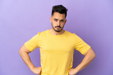 Young caucasian man isolated on purple background angry