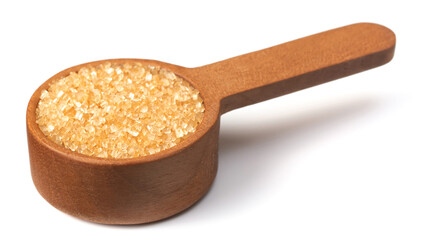 yellow sanding sugar in the wooden measuring spoon, isolated on white background