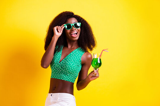 Photo portrait of woman wearing stylish outfit laughing keeping cocktail at party isolated bright yellow color background
