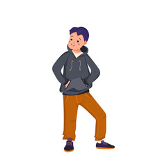 Boy in a hoodie, jeans and sneakers stands and smiles. Happy child holds his hands in the poop. Teenager with face and eyes in casual clothes. World International children day