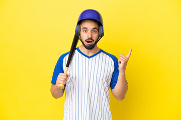 Young caucasian man playing baseball isolated on yellow background thinking an idea pointing the finger up