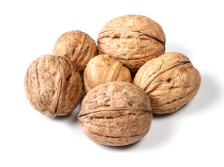 several whole walnuts closeup on white
