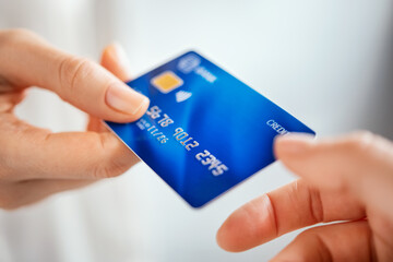 Woman hand passing credit card
