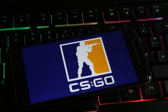 Viersen, Germany - May 9. 2021: Closeup of smartphone with logo lettering cs go counter strike global offensive on computer keyboard