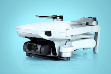 Gray mini quadcopter on a blue background
