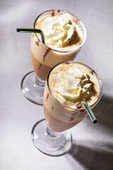 Freddoccino, frappuccino coffee drink in tall glass with metal reusable straws