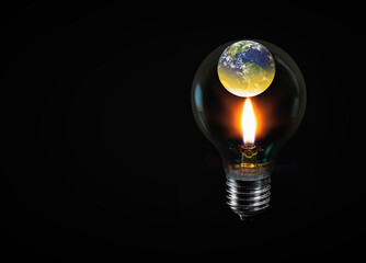 Global Warming Concept - Our planet Earth in a light bulb and the candle flame that warms it "Elements of this image furnished by NASA "