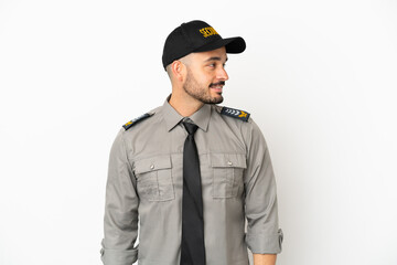 Young security  caucasian man isolated on white background looking side