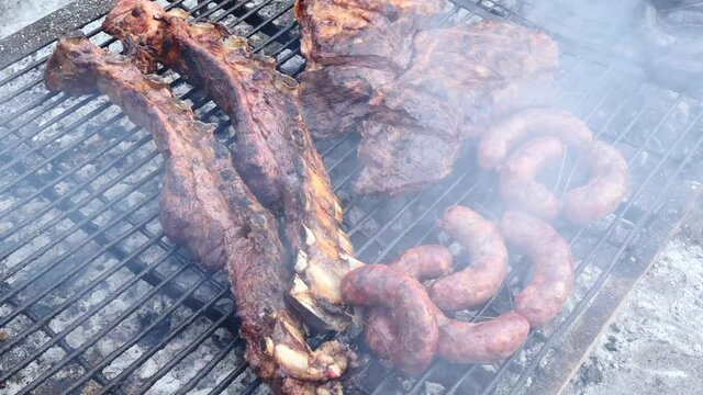 Parrilla, Smoky grill with pieces of a traditional Argentinian barbecue or asado