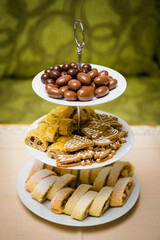 Stand with three plates and sweet treats.